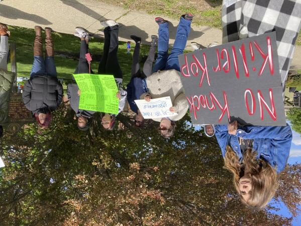 Protesters stand on a street corner in Carrollton, Ky. on Monday, April 24, 2023, to protest the hiring of a former Louisville police officer who shot Breonna Taylor. Myles Cosgrove was recently hired by the Carroll County sheriffs department. (AP Photo/Dylan Lovan)