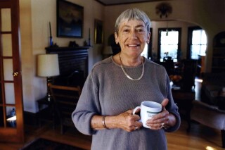 FILE - Ursula K. Le Guin, an American author of novels and children's books, poses for a photo at home on Sept. 9, 2001, in Portland, Ore. The former home of the late Le Guin is being readied to become a base for contemporary authors. Literary Arts announced Monday, June 10, 2024, that Le Guin’s family had donated their three-story house to the Portland, Oregon-based community nonprofit for what will become the Ursula K. Le Guin Writers Residency. (Benjamin Brink/The Oregonian via ĢӰԺ)