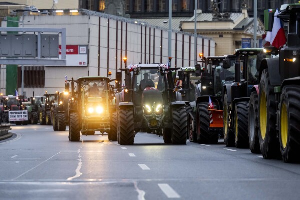 Farmers with tractors stand on a street in the centre of the Czech capital during a demonstration to draw attention to the poor situation of Czech agriculture in Prague, Monday, Feb. 19, 2024. Some Czech farmers rallied in the capital on Monday to protest the European Union policies on in agriculture and unfair conditions for doing their business. Hundreds of tractors and other vehicles blocked one line on a major road in downtown Prague but traffic was not halted. Anticipating a possible collapse of traffic, City Hall warned people not to drive to Prague on Monday. (Ondrej Deml/CTK via AP)