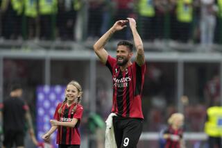 AC Milan's Olivier Giroud celebrates at the end of the Serie A soccer match between AC Milan and Atalanta at the San Siro stadium, in Milan, Italy, Sunday, May 15, 2022. Milan won 2-0. (AP Photo/Antonio Calanni)