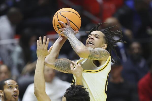 Grambling State guard Virshon Cotton, rear shoot the ball against Southern during the NBA All-Star HBCU classic college basketball game Saturday, Feb. 18, 2023, in Salt Lake City. (AP Photo/Rob Gray)