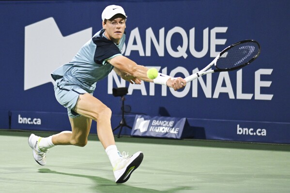 Jannik Sinner, of Italy, plays a shot to Andrey Rublev, of Russia, during their quarterfinal match at the National Bank Open tennis tournament in Montreal, Saturday, Aug. 10, 2024. (Graham Hughes/The Canadian Press via AP)