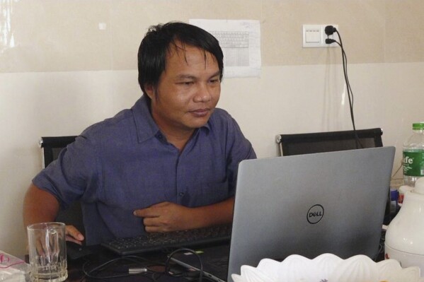 Sai Zaw Thaike, a photojournalist for the independent news website Myanmar Now, works at his desk in Yangon, Myanmar in August 2020. Sai Zaw Thaike was arrested in the western state of Rakhine in May this year while covering the aftermath of Cyclone Mocha, and sentenced on Wednesday, Sept. 6, 2023 to 20 years in prison by a military tribunal in Yangon, according to Myanmar Now. (Myanmar Now via AP)