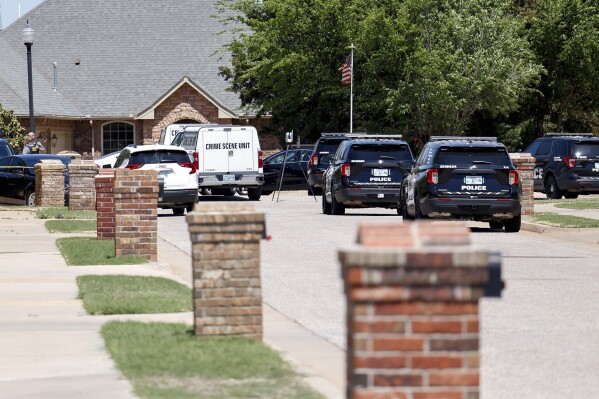 Oklahoma City police investigate after 5 were found dead in a home in Oklahoma City, on Monday, April 22, 2024. Oklahoma City police called to a home on the city's southwest side Monday discovered the bodies of five people, including at least two children, authorities said. (Nathan J. Fish/The Oklahoman via AP)