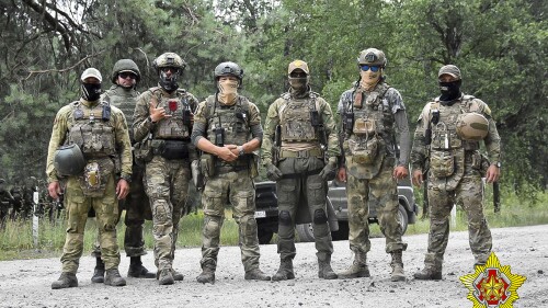 In this photo released by Belarus' Defense Ministry on Thursday, July 20, 2023, Belarusian soldiers of the Special Operations Forces (SOF) and mercenary fighters from Wagner private military company pose for a photo while the weeklong maneuvers that will be conducted at a firing range near the border city of Brest, Belarus. Mercenaries from Russia's military company Wagner have launched joint drills with the Belarusian military near the border with Poland following their relocation to Belarus after their short-lived rebellion. (Belarus' Defense Ministry via AP)