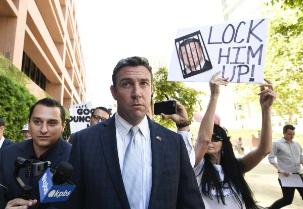 CORRECTS TO ATTRIBUTE THE REFERENCE TO HUNTER, NOT A JUSGE - FILE - In this July 1, 2019, file photo, U.S. Rep. Duncan Hunter leaves federal court after a motions hearing in San Diego. The California Republican plans to plead guilty on Tuesday, Dec. 3, 2019, to the misuse of campaign funds and has indicated he will leave Congress, he told KUSI television in San Diego in an interview that aired Monday. (AP Photo/Denis Poroy, File)