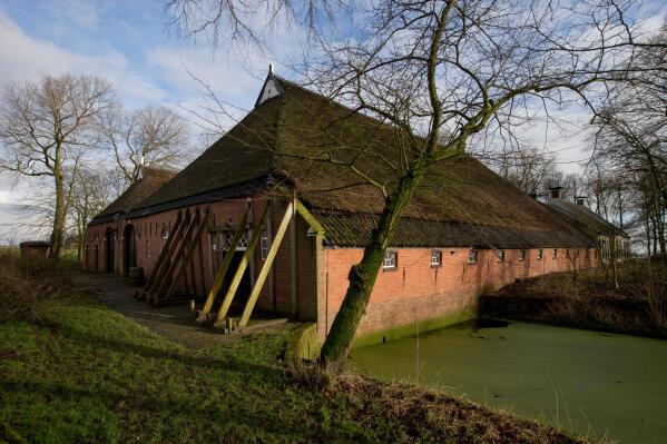 FILE - Support beams stabilize an historic farm after a series of small tremors caused by decades of gas extraction, in Hunzinge, in Groningen province, northern Netherlands on Friday, Jan. 19, 2018. Dutch Prime Minister Mark Rutte apologized Tuesday, april 25, 2023 to residents of the northern province of Groningen who have suffered for years from earthquakes caused by gas extraction that damaged thousands of homes and ruined lives. (AP Photo/Peter Dejong, file)