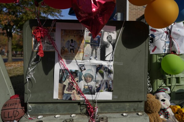 Images of Dominic Davis, an 11-year-old boy who was killed in a weekend shooting, are part of a makeshift memorial, Monday, Nov 6, 2023, in Cincinnati. Police Chief Terri Theetge told reporters Sunday that a shooter in a sedan fired 22 rounds 