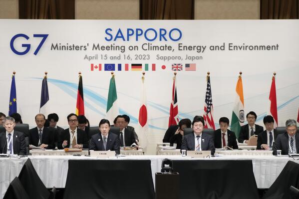 Japan's Economy Minister Yasutoshi Nishimura, center left, with Environment Minister Akihiro Nishimura, center right, speaks at the beginning of a plenary session in the G-7 ministers' meeting on climate, energy and environment as they co-chair the meeting in Sapporo, northern Japan, Saturday, April 15, 2023. (AP Photo/Hiro Komae)
