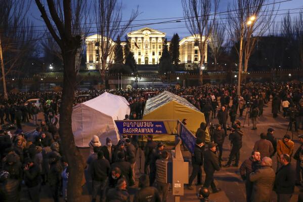 Opposition demonstrators set up tents as they rally to pressure Armenian Prime Minister Nikol Pashinyan to resign in the center of Yerevan, Armenia, Thursday, Feb. 25, 2021. Armenia's prime minister has spoken of an attempted military coup after facing the military's General Staff demand to step down. The developments come after months of protests sparked by the nation's defeat in the Nagorno-Karabakh conflict with Azerbaijan. (Hayk Baghdasaryan/PHOTOLURE via AP)