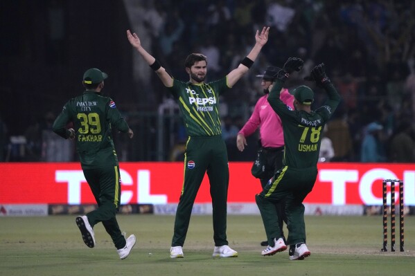 Pakistan's Shaheen Shah Afridi, center, celebrates with teammates after taking the wicket of New Zealand's James Neesham during the fifth T20 international cricket match between Pakistan and New Zealand, in Lahore, Pakistan, Saturday, April 27, 2024. (AP Photo/K.M. Chaudary)