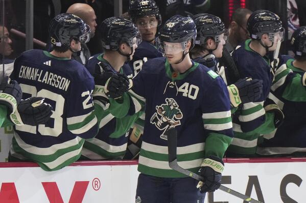 Vancouver Canucks' Elias Pettersson is congratulated for a goal against the Los Angeles Kings during the second period of an NHL hockey game Friday, Nov. 18, 2022, in Vancouver, British Columbia. (Darryl Dyck/The Canadian Press via AP)