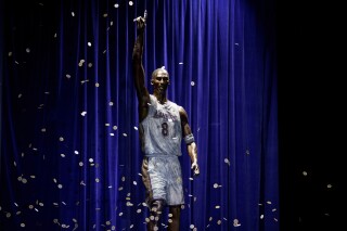 FILE - A statue in honor of former Los Angeles Lakers guard Kobe Bryant is displayed after being unveiled in a ceremony outside the NBA basketball team's arena, Feb. 8, 2024, in Los Angeles. The Lakers say they're planning to fix a handful of errors on the base of the statue of Kobe Bryant unveiled last month outside their arena. (AP Photo/Eric Thayer, File)