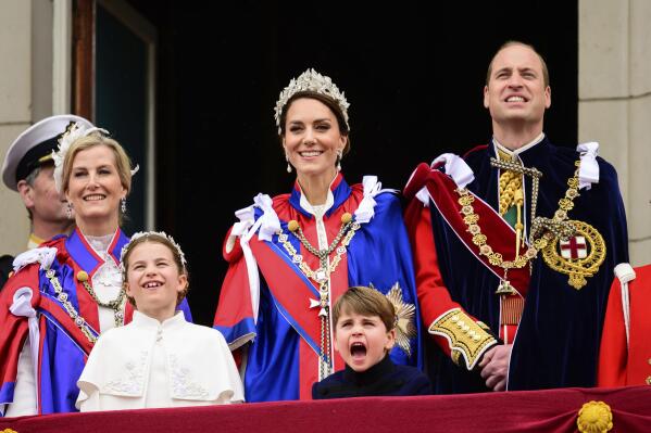 Sophie, Duchess of Edinburgh, left, Kate, Princess of Wales, centre, Prince William, right, stand on the balcony of Buckingham Palace with Princess Charlotte, down left, and Prince Louis, down centre, during the coronation of Britain's King Charles III, in London, Saturday, May 6, 2023. (Leon Neal/Pool Photo via AP)