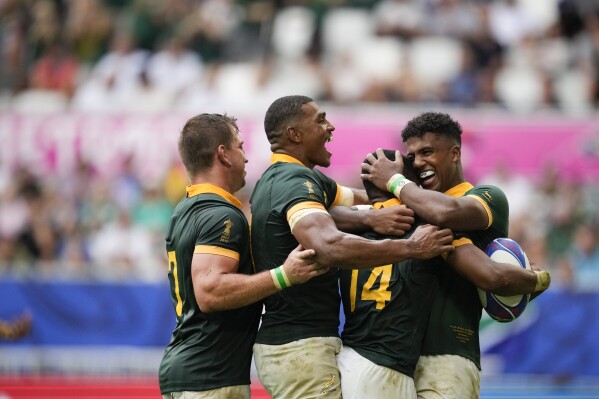 South Africa's Grant Williams, 14, celebrates with teammates after marking a try during the Rugby World Cup Pool B match between South Africa and Romania at the Stade de Bordeaux in Bordeaux, France, Sunday, Sept. 17, 2023. (AP Photo/Christophe Ena)
