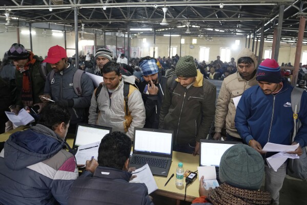 Indian workers aspiring to be hired for jobs in Israel submit their forms during a recruitment drive in Lucknow, India, Thursday, Jan. 25, 2024. (AP Photo/Rajesh Kumar Singh)