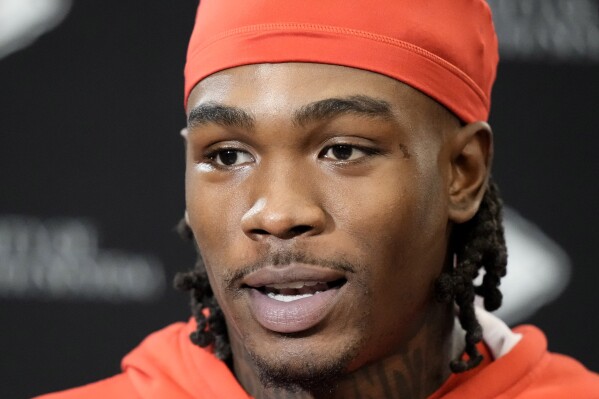 FILE - Kansas City Chiefs wide receiver Rashee Rice speaks to the media before the NFL football team's practice Thursday, Jan. 25, 2024, in Kansas City, Mo. A spokeswoman for Rice’s attorney, Texas state Sen. Royce West, confirmed to The Associated Press, late Thursday, April 11, 2024, that Rice turned himself in at the Glenn Heights Police Department, in Texas, on charges including aggravated assault after he and another driver of a speeding sports car allegedly caused a crash involving a half-dozen vehicles on a Dallas highway the previous month. (AP Photo/Charlie Riedel, File)