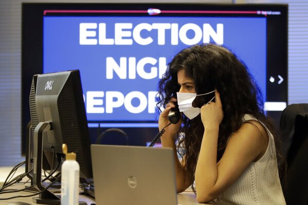 Ohio election official Parvinder Singh wears a mask while working in the election night reporting center in Columbus, Ohio, as returns begin to come in for the Ohio primary Tuesday, April 28, 2020. (AP Photo/Gene J. Puskar)