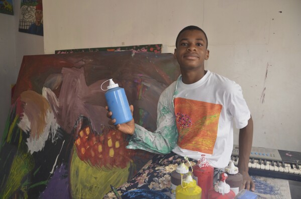 Kanyeyachukwu Tagbo Okeke, a 15 year-old autistic Nigerian, who set a Guinness World Record for the world's largest art canvas, is photograph during an interview in Abuja, Nigeria, Friday, April 18, 2025. (AP Photo/Olamikan Gbemiga)