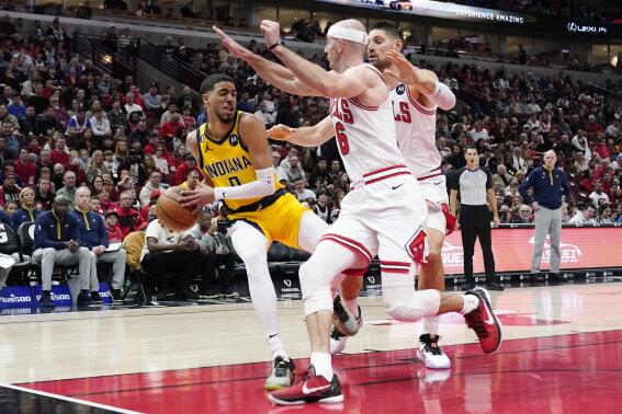 Chicago Bulls guard Alex Caruso, center, and center Nikola Vucevic, right, guard Indiana Pacers guard Tyrese Haliburton during the first half of an NBA basketball game in Chicago, Sunday, March 5, 2023. (AP Photo/Nam Y. Huh)