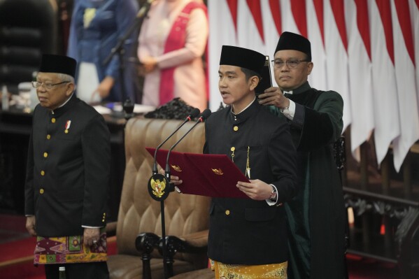 Indonesia's Newly-inaugurated vice president-elect Gibran Rakabuming Raka, who is also the eldest son of outgoing President Joko Widodo, takes the oath during the presidential inauguration ceremony at the Parliament building in Jakarta, Indonesia, Sunday, Oct. 20, 2024. (AP Photo/Tatan Syuflana)