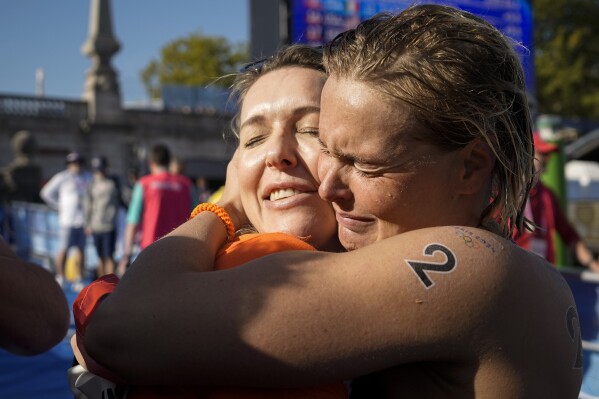 Sharon Van Rouwendaal, of the Netherlands, right, celebrates with her sister Mandy after crossing the finish line at the end of the marathon swimming women's 10km competition at the 2024 Summer Olympics, Thursday, Aug. 8, 2024, in Paris, France. (AP Photo/Vadim Ghirda)