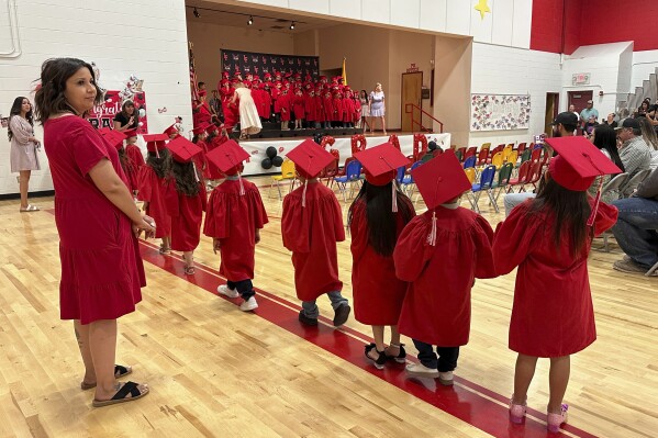 Kindergartners at Loving Elementary School line up for a procession during their graduation ceremony in Loving, N.M., on Tuesday, May 20, 2025. (AP Photo/Susan Montoya Bryan)