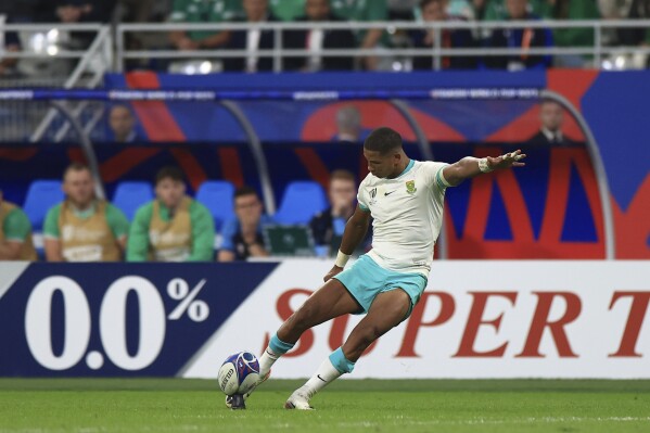 South Africa's Manie Libbok attempts a penalty kick during the Rugby World Cup Pool B match between South Africa and Ireland at the Stade de France in Saint-Denis, outside Paris, Saturday, Sept. 23, 2023. (AP Photo/Aurelien Morissard)