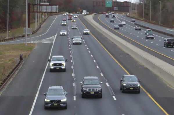 Cars drive on the Garden State Parkway in Brick, N.J. on Tuesday, Nov. 21, 2023, the same day that New Jersey officials said they will move to end the sale of new gasoline-powered vehicles in the state by 2035. (AP Photo/Wayne Parry)