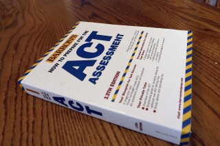 FILE - An ACT Assessment preparation book is seen, April 1, 2014, in Springfield, Ill. High school students' scores on the ACT college admissions test for 2023 dropped to their lowest in more than three decades, showing a lack of student preparedness for college-level coursework, the nonprofit organization that administers the test said Wednesday, Oct. 11, 2023. (AP Photo/Seth Perlman, File)