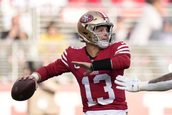 San Francisco 49ers quarterback Brock Purdy (13) passes against the Seattle Seahawks during the first half of an NFL football game in Santa Clara, Calif., Sunday, Dec. 10, 2023. (AP Photo/Godofredo A. Vásquez)