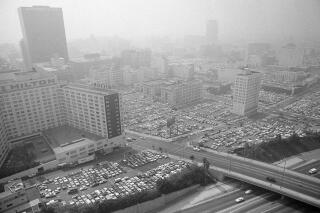 FILE - This Sept. 13, 1979, file photo shows motorists as downtown parking lots fill up in Los Angeles. Over 170 million of people born in the United States who were adults in 2015 were exposed to harmful levels of lead as children, according to a study published in the Proceedings of the National Academy of Sciences on Monday, March 7, 2022. The researchers looked only at lead exposure caused by leaded gasoline, the dominant form of lead exposure from the 1940s to the late 1980s, according to data from the U.S. Geological Survey. (AP Photo/Wally Fong, File)