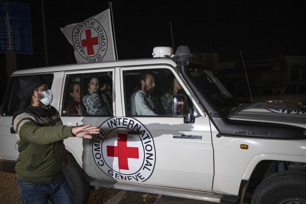 FILE - A Red Cross vehicle carrying Israeli hostages drives by at the Gaza Strip crossing into Egypt in Rafah on Saturday, Nov. 25, 2023. The International Committee of the Red Cross has been losing influence, funding and staff. Now, disparaging remarks from Israeli Prime Minister Benjamin Netanyahu are the latest headache for the Geneva-based humanitarian aid group. (AP Photo/Fatima Shbair, File)