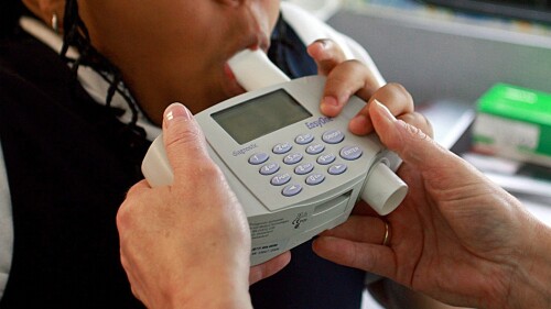 FILE - An 8-year-old student blows into a spirometer held by a nurse outside an elementary school in Bel Nor, Mo., in May 2009. The Doris Duke Charitable Foundation is awarding more than $10 million to five health organizations to reconsider the use of race in medical algorithms, which research shows can lead to potentially dangerous results for patients of color. (Christian Gooden/St. Louis Post-Dispatch via AP, File)