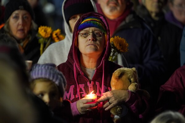 Community members gather Thursday, Nov. 2, 2023, during a candlelight vigil in Auburn, Maine. Locals seek a return to normalcy after a mass shooting in Lewiston on Oct. 25. (AP Photo/Matt York)
