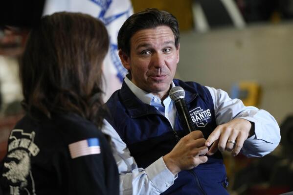 Republican presidential candidate Florida Gov. Ron DeSantis talks with his wife Casey, left, during a campaign event at Port Neal Welding, Wednesday, May 31, 2023, in Salix, Iowa. (AP Photo/Charlie Neibergall)