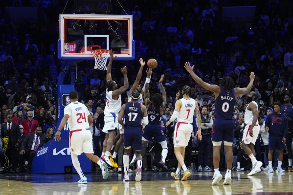 Philadelphia 76ers' Kelly Oubre Jr. (9) cannot get a shot past Los Angeles Clippers' Paul George (13) and Kawhi Leonard (2) as time expires in their NBA basketball game, Wednesday, March 27, 2024, in Philadelphia. (AP Photo/Matt Slocum)
