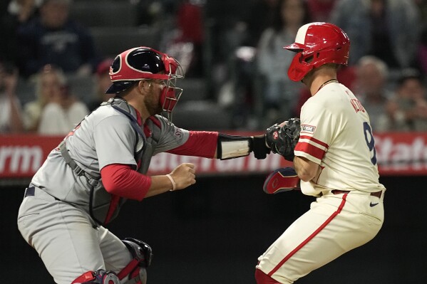 Los Angeles Angels' Zach Neto, right, is tagged out by St. Louis Cardinals catcher Pedro Pages as he tries to steal home during the eighth inning of a baseball game Tuesday, May 14, 2024, in Anaheim, Calif. (AP Photo/Mark J. Terrill)