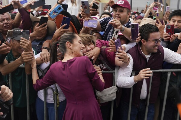 FILE - Presidential candidate Claudia Sheinbaum greets supporters as she arrives to her opening campaign rally at the Zocalo in Mexico City, March 1, 2024. Sheinbaum, a former mayor of Mexico City and the governing party’s candidate, has kept a comfortable lead in all polls over her two opponents. (AP Photo/Aurea Del Rosario, File)
