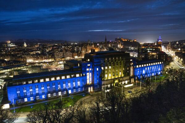 St Andrew's House in Edinburgh, Scotland, is lit up with the colours of the Ukraine flag, Friday, Feb. 25, 2022. Russia has launched a full-scale invasion of Ukraine, unleashing airstrikes on cities and military bases and sending troops and tanks from multiple directions in a move that could rewrite the world's geopolitical landscape. (Jane Barlow/PA via AP)