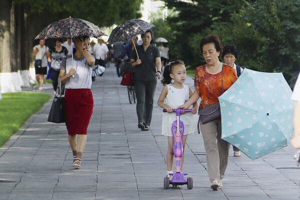 FILE - People walk in the Ryomyong street in Pyongyang, North Korea, Tuesday, Aug. 8, 2023. North Korea said Sunday, Aug. 27, it will allow its citizens staying abroad to return home in line with easing pandemic situations worldwide, as the country slowly eases its draconian pandemic restrictions. (AP Photo/Cha Song Ho, File)