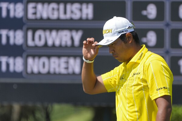 Hideki Matsuyama, of Japan, tips his cap to the gallery after putting out on the second green during the final round of The Players Championship golf tournament Sunday, March 17, 2024, in Ponte Vedra Beach, Fla. (AP Photo/Marta Lavandier)