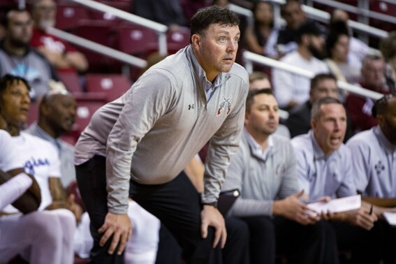 FILE - New Mexico State coach Greg Heiar watches players during a game Nov. 2, 2022, in Las Cruces, N.M. Heiar said in a document released Thursday, Aug. 3, 2023, that he was made the scapegoat for hazing and other problems that administrators chose to ignore and that he has suffered mental anguish and emotional distress since being fired by the university. (Meg Potter/The Las Cruces Sun News via AP, File)