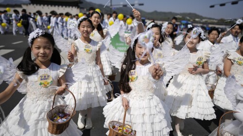 FILE - Children dressed as angels march during an Easter parade in Seoul, South Korea, on April 9, 2023. A new law that went into effect Wednesday, June 28, formalizes the international age-counting method as standard in administrative and civil laws and encourages people to tally their own ages accordingly. The country's previous age-counting method made people a year or two older than they really are. (AP Photo/Lee Jin-man, File)