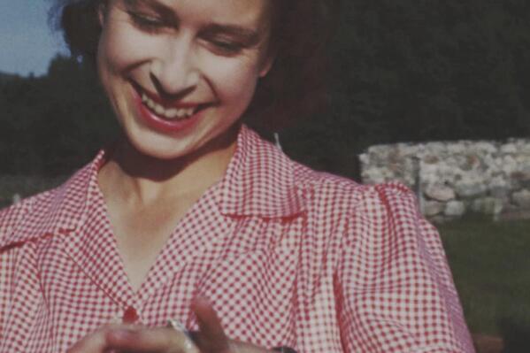 An image taken from the video 'Elizabeth: The Unseen Queen' of then Princess Elizabeth showing off her new engagement ring soon after Prince Philip's marriage proposal at Balmoral in 1946. A new documentary set to be released will reveal unseen footage of Queen Elizabeth II. The BBC has been given broad access to a huge archive of homemade films shot by the Queen, her parents and her husband, the Duke of Edinburgh. The film is being made in conjunction with upcoming celebrations for the Queen's Platinum Jubilee. (The Royal Collection via BBC Studios via AP)