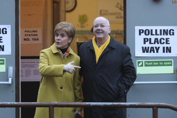 FILE - Scottish First Minister Nicola Sturgeon poses for the media with husband Peter Murrell, outside polling station in Glasgow, Scotland, on Dec. 12, 2019. Scotland police say the treasurer of the Scottish National Party has been arrested in a party finance probe. Colin Beattie, a member of Scottish Parliament, was arrested Tuesday, April 18, 2023 in an investigation into how 600,000 pounds ($745,000) designated for a Scottish independence campaign was spent. The arrest comes two weeks after the party's executive director was taken into custody and released without charges. The executive director, Peter Murrell, is the husband of former Scottish first minister and party leader Nicola Sturgeon. (AP Photo/Scott Heppell, File)