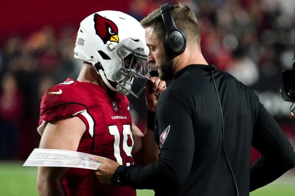 Arizona Cardinals quarterback Trace McSorley (19) talks with head coach Kliff Kingsbury during the second half of an NFL football game against the Tampa Bay Buccaneers, Sunday, Dec. 25, 2022, in Glendale, Ariz. The Buccaneers defeated the Cardinals 19-16 in overtime. (AP Photo/Darryl Webb)