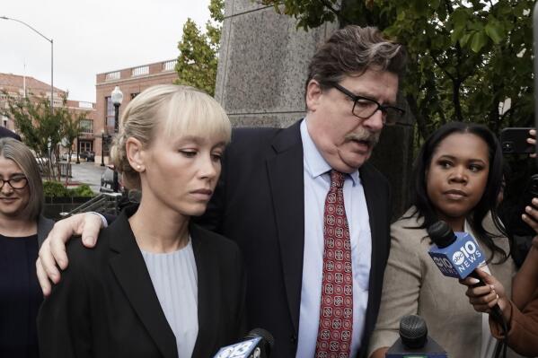 Sherri Papini arrives at the federal courthouse for sentencing accompanied by her attorney, William Portanova, right, in Sacramento, Calif., Monday, Sept. 19, 2022. Federal prosecutors are asking that she be sentenced to eight months in prison for faking her own kidnapping in 2016. (AP Photo/Rich Pedroncelli)