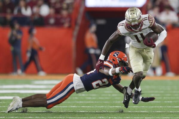 Florida State wide receiver Malik McClain (11) avoids a tackle by Syracuse defensive back Jeremiah Wilson (24) during the first half of an NCAA college football game Saturday, Nov. 12, 2022, in Syracuse, N.Y. (AP Photo/Joshua Bessex)