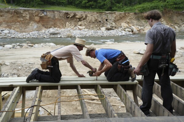 Amish volunteers from Pennsylvania rebuild a deck along the banks of the Broad River in Chimney Rock Village, N.C., on Monday, May 19, 2025. (Shelly McCormack via AP)